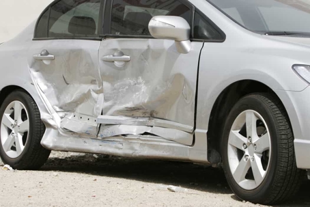 Silver compact car with smashed passenger's side after a car accident
