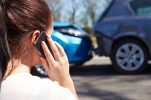 woman on her phone after a car accident