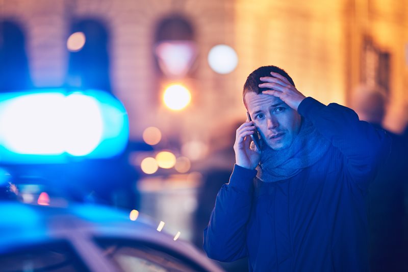 man calling police after car accident