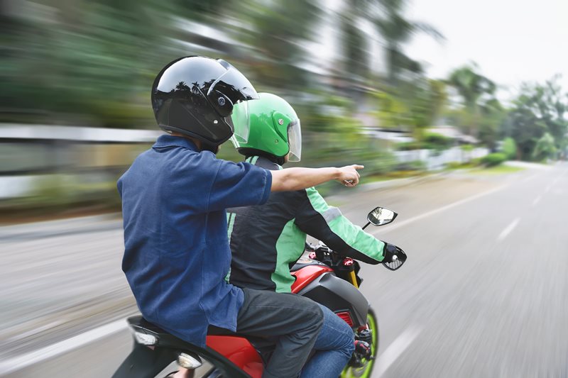 motorcyclist and passenger riding on highway