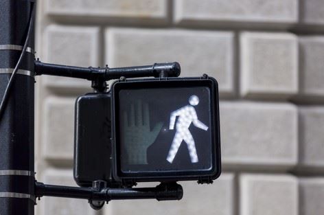 pedestrian crosswalk light with walk sign